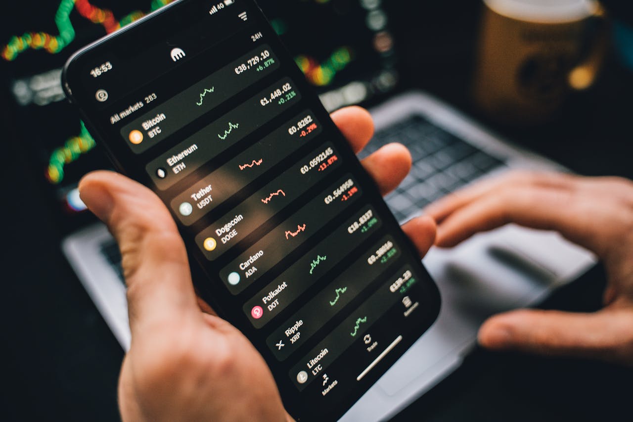 person holding smartphone showing cryptocurrency market data symbolizing digital investment tools 币安app